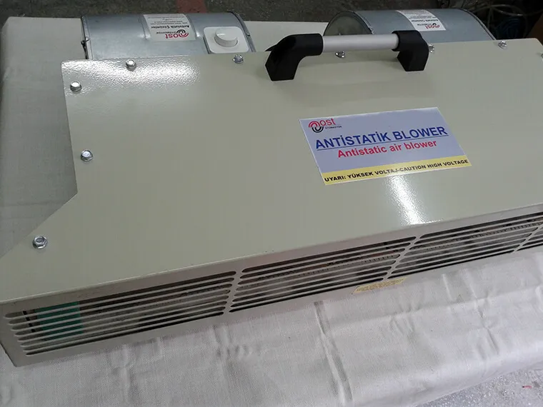 Cream-colored ionizing blower with a carrying handle and two fan motors at the back